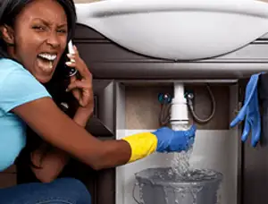 Emergency plumbing repair for a leaking sink drain under a bathroom vanity in Philadelphia, PA