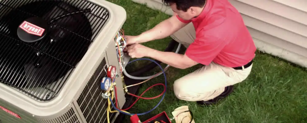 HVAC technician servicing an outdoor air conditioner unit in Philadelphia, PA