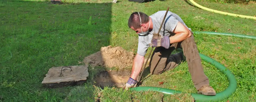 Septic pumping technician servicing a residential septic tank in Philadelphia, PA